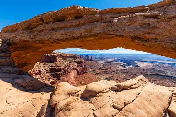 stock image The most famous landmark of the Island in the Sky District of Canyonlands national park in Utah USA - The Mesa Arch in a blue day.