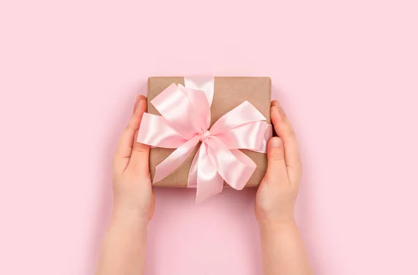 Руки Дівчини Тримають Подарункову Коробку Рожевою Стрічкою Пастельному Рожевому Фоні — стокове фото