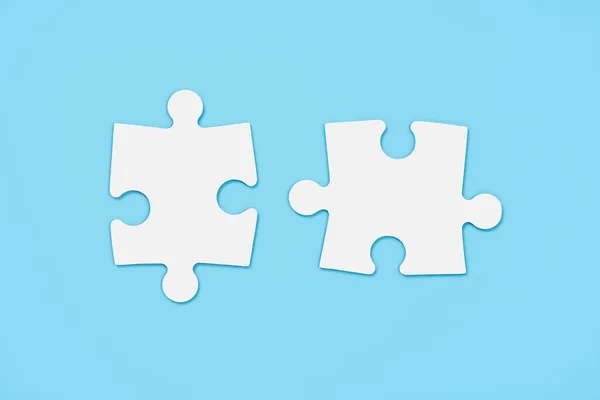 Mavi arkaplanda iki beyaz eşleşen yapboz parçası