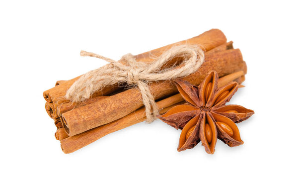 Twine tied cinnamon sticks and star anise isolated on white background