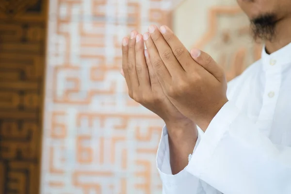 Hand of muslim people praying. Muslim islam man in white session lift two hand for praying. Concept for islamic pray, Ramadan, Eid al Fitr, Meditation