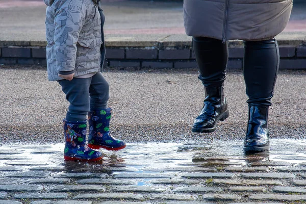 Little Boy Splashing Puddle While Out Walking Park His Mum — Stock Photo, Image