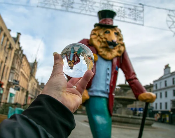 photography glass ball in human hand photographing colourful lion statute, art, abstract, interesting, colourful statue