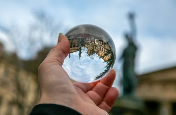 photographic glass ball in human hand taking urban photos, artistic, art, abstract