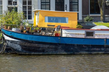 Water, canals, bridges and boats on the canals in Amsterdam city clipart