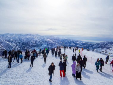 Chimgan, Uzbekistan - January 27, 2024: People on the top of the Amirsoy Ski Resort. clipart