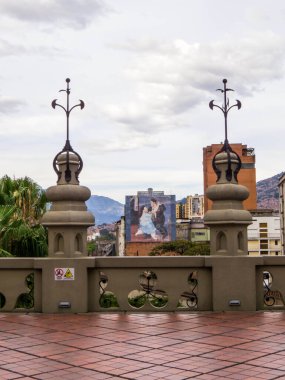 View of the Fernando Botero painting from the Rafael Uribe Uribe Palace of Culture, Plaza Botero, Medellin, Colombia clipart