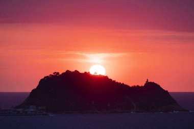 Günbatımı güneşi denizin üzerinde ve Getaria kıyılarında, Euskadi