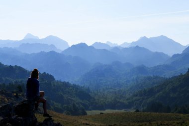 Route of the Golondrinas. Woman next to the Balagua Refuge, Pyrenees of Navarre. clipart