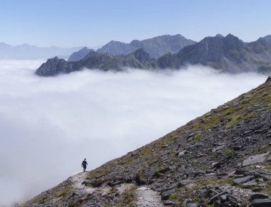 Hiker on the Col de Petrechema. Hiker on the Camile Trail, route of the swallows, cirque de Lescun, France. clipart