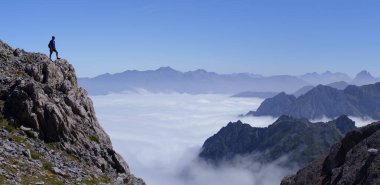 Hiker on the Col de Petrechema. Hiker on the Camile Trail, route of the swallows, cirque de Lescun, France. clipart