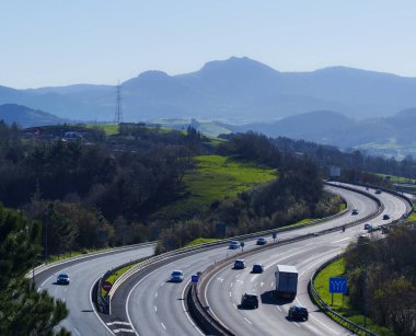 Traffic towards the city of Donostia. Cars on the A8 highway near the city of Donostia - San Sebastian, Euskadi. clipart