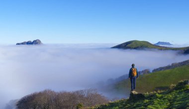 Mist in the Aiako Harriak Natural Park. Hiker with sea of clouds in Aiako Harriak Natural Park, Euskadi clipart