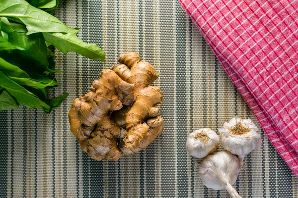 stock image fresh ginger and garlic on a wooden background