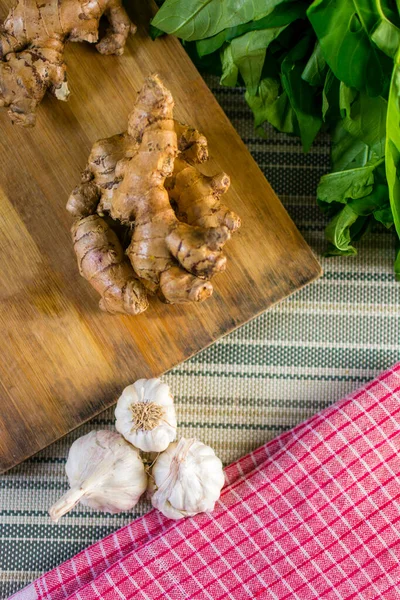 stock image fresh ginger and garlic on a wooden board