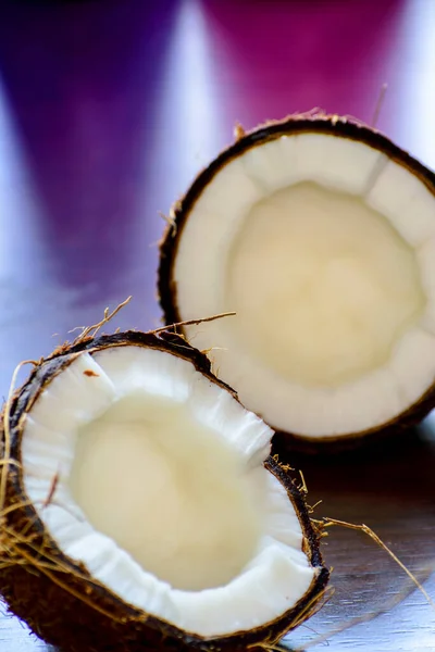 fresh coconuts with half of coconut, closeup view