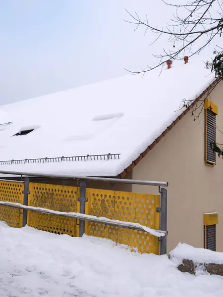 Winter in January, house with snow on roof and solar,
