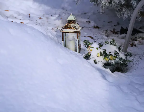 a small lantern is sitting in the snow