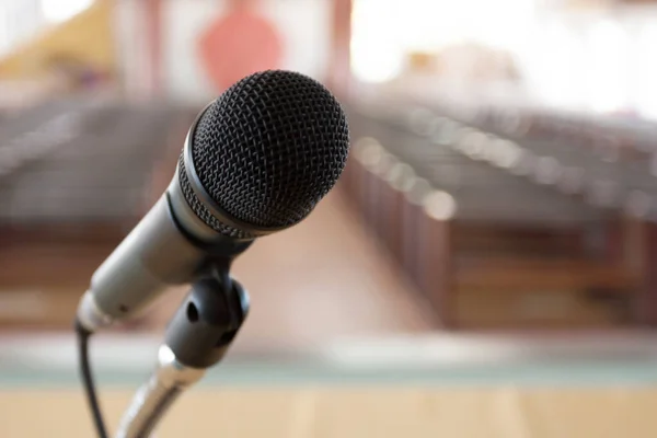 Microphone on stage with conference hall background