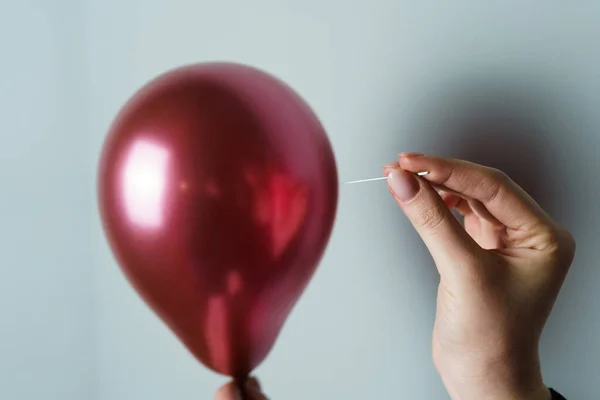 Stock image Woman Holding a Needle Close to a Balloon to Pop