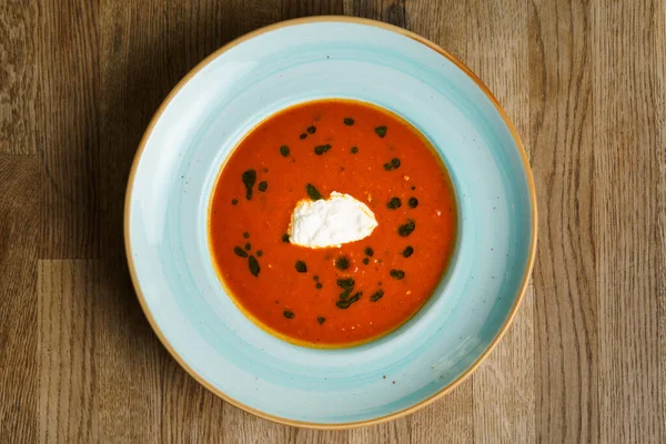 stock image Top Down view of Tomato Soup with burrata and homemade pesto on a wooden table.