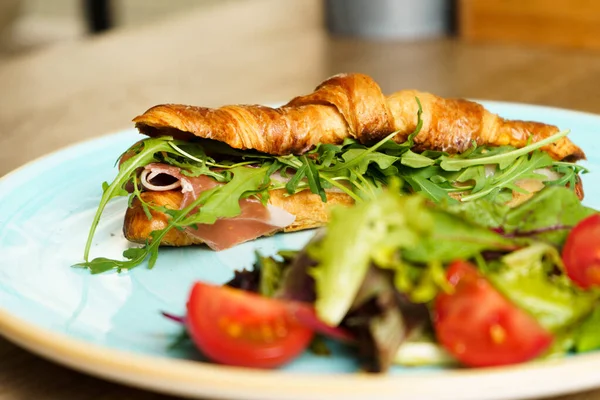 stock image Croissant with ham, vegetables and cheese.