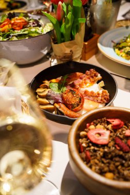 Kızarmış yumurta, sosis, pastırma, mantar ve domatesli İngiliz kahvaltısı.