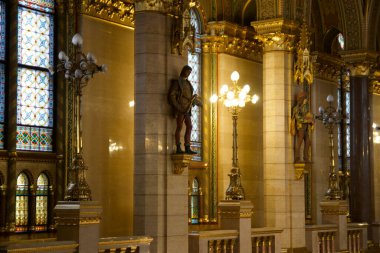 BUDAPEST, HUNGARY - MARCH 03, 2019: Gallery with lots of gold, marble, and sandstone inside the Budapest Parliament building, the seat of the government of Hungary.