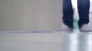 Blurred Shooting with a Man Letting at the Door a Package for Mail Courier Delivery. Concept of Postage Delivery from the Door.