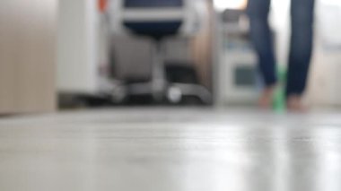 Blurred Shooting with a Person in Bare Feet Walking Out of His Room. Elderly Person Walks Out of the Bedroom.