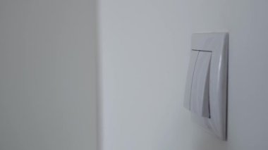 Businessman Starting Lights in the Office. Shooting with a Hand Opening the Light in a Room Pushing the Switch from the Wall.