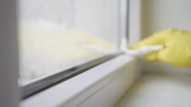 Temiz mendil ve dezenfektan sıkarak pencereyi temizlerken bulanık çekim. Ev İşleri ve Faaliyetleri.