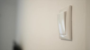 Shutting the Light from the Switch in the Office. A Person Turning off the Light in a Room. Saving Electricity, Economy Concept.