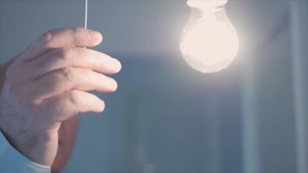 One Person Pulls Switch Cord Turns Light Room Saving Electricity — Vídeos de Stock