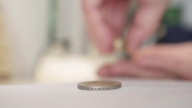 Man Putting Metallic Coins on Top of Each Other Making a Stock, Calculating Expenses and Trying to Make Economy. Financial Concept of Man Planning Savings and Expenses with Cash Money.