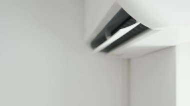 Air Conditioning Blowing Fresh Cool Air in the Office Changing the Room Temperature. Cooling Device Technology in Function. Split System. Shooting with an Air-Conditioner Working on a Hot Summer Day.
