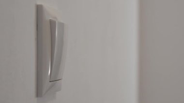 Shutting the Light from the Switch in the Office. A Person Turning off the Light in a Room. Saving Electricity, Economy Concept.