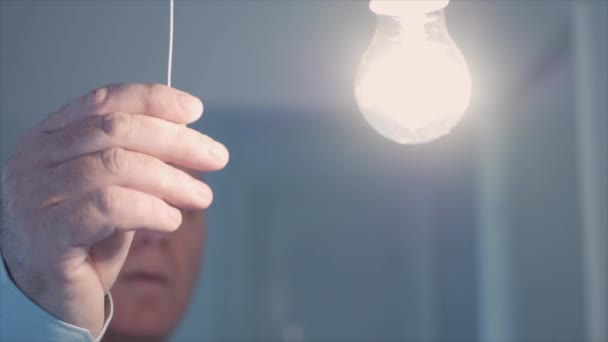 One Person Pulls Switch Cord Turns Light Room Saving Electricity — Stockvideo