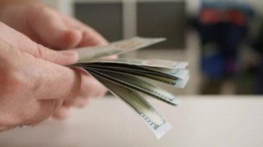 Blurred Shooting with a Man Counting Cash Money, Calculating Salary Payments, and Paying in Cash. Financial Investments Concept.