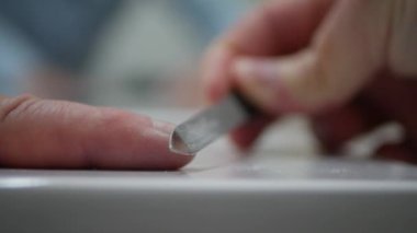 Blurred Shooting with a Man File His Nails with a Nail File.  Person Making Own Manicure at Home.