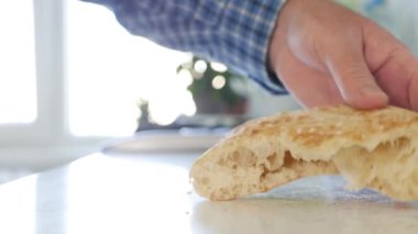 Man Putting on the Table Hot and Appetizing Different Fresh Homemade Pieces of Bread. Bakery Products Presentation on the Table.