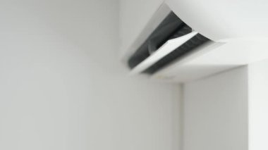 Air Conditioning Blowing Fresh Cool Air in the Office Changing the Room Temperature. Cooling Device Technology in Function. Split System. Shooting with an Air-Conditioner Working on a Hot Summer Day.