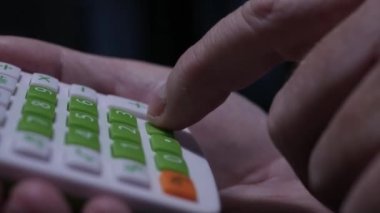 Blurred Shooting with a Man Calculating with an Adding Machine. Businessman Using a Calculator at Office.