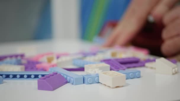 Blurred Shooting Elderly Person Playing Child Colorful Small Toy Bricks — Wideo stockowe