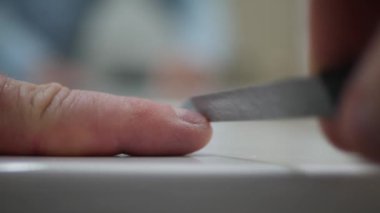 Blurred Shooting with a Man File His Nails with a Nail File.  Person Making Own Manicure at Home.
