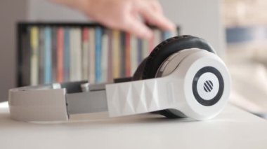 Blurred Shooting with a Man Taking a CD with Music from His Music Collection.