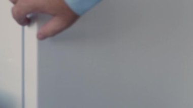 Man Hand Opens an Empty Fridge Door Looking Inside for Fresh Food and Drink. Empty Fridge, Food Crisis Concept.