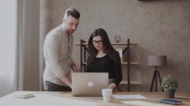 Erkek iş arkadaşı proje sonuçlarını gösteren belgeyi beyaz kadın meslektaşla konuşuyor. Muhtelif iş adamları, istişare analizi, proje tartışması, ofiste çizelge ve grafiklerle sonuçlanıyor.