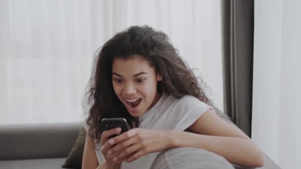 Overjoyed Millennial African American Woman Look Cellphone Screen Celebrate Triumph — Stock videók