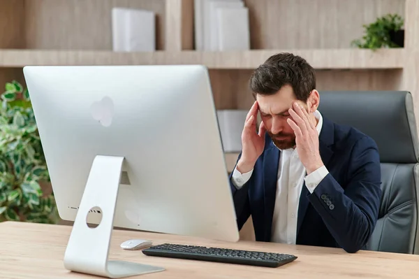 an executive or an office worker closing his eyes from the tiredness, and headache and migraine